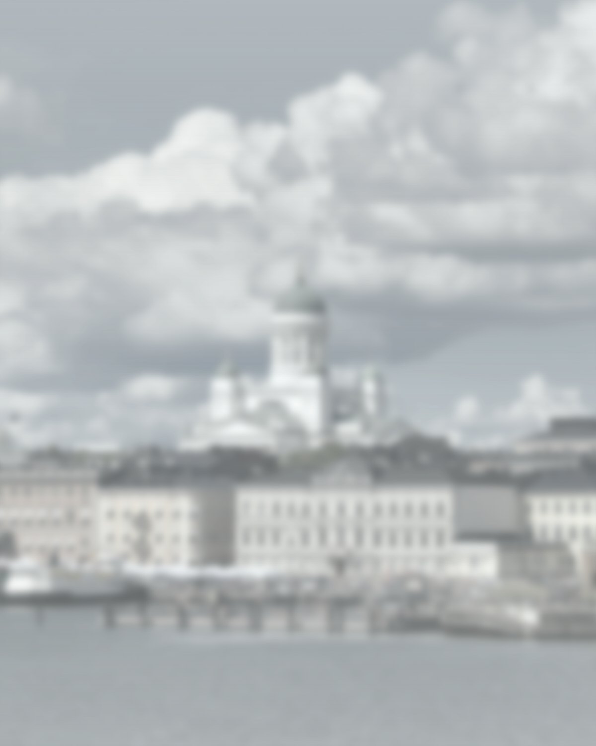 A light, frosted photograph of Helsinki, with Helsinki Cathedral above the harbor.